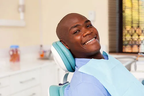 smiling man in dental chair